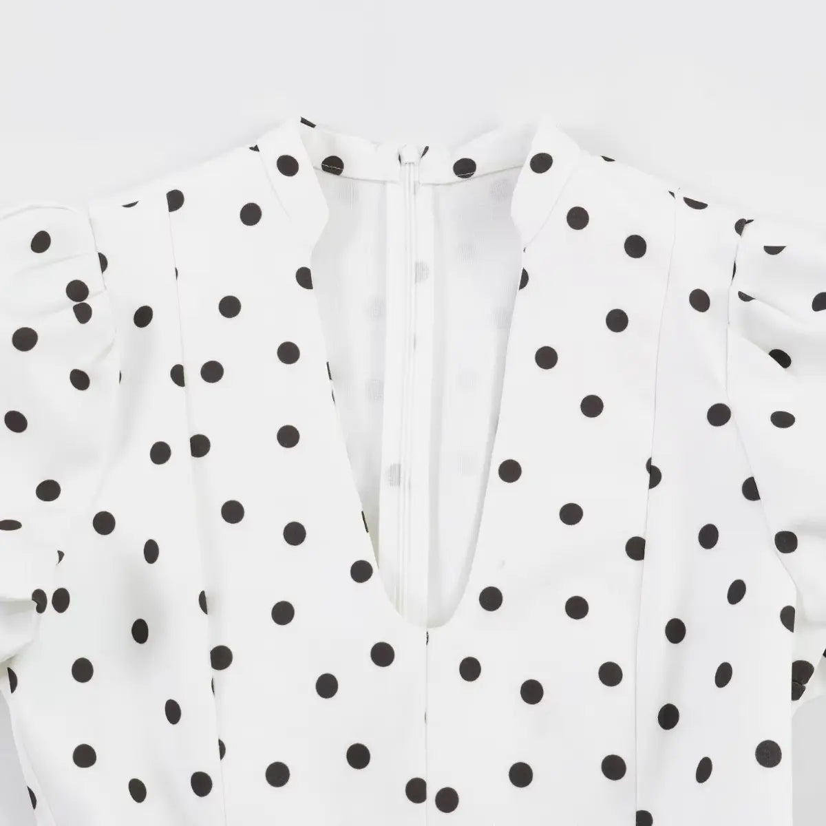 Full back view of the dress, showing the standing collar, center zipper, and both puffed sleeves.