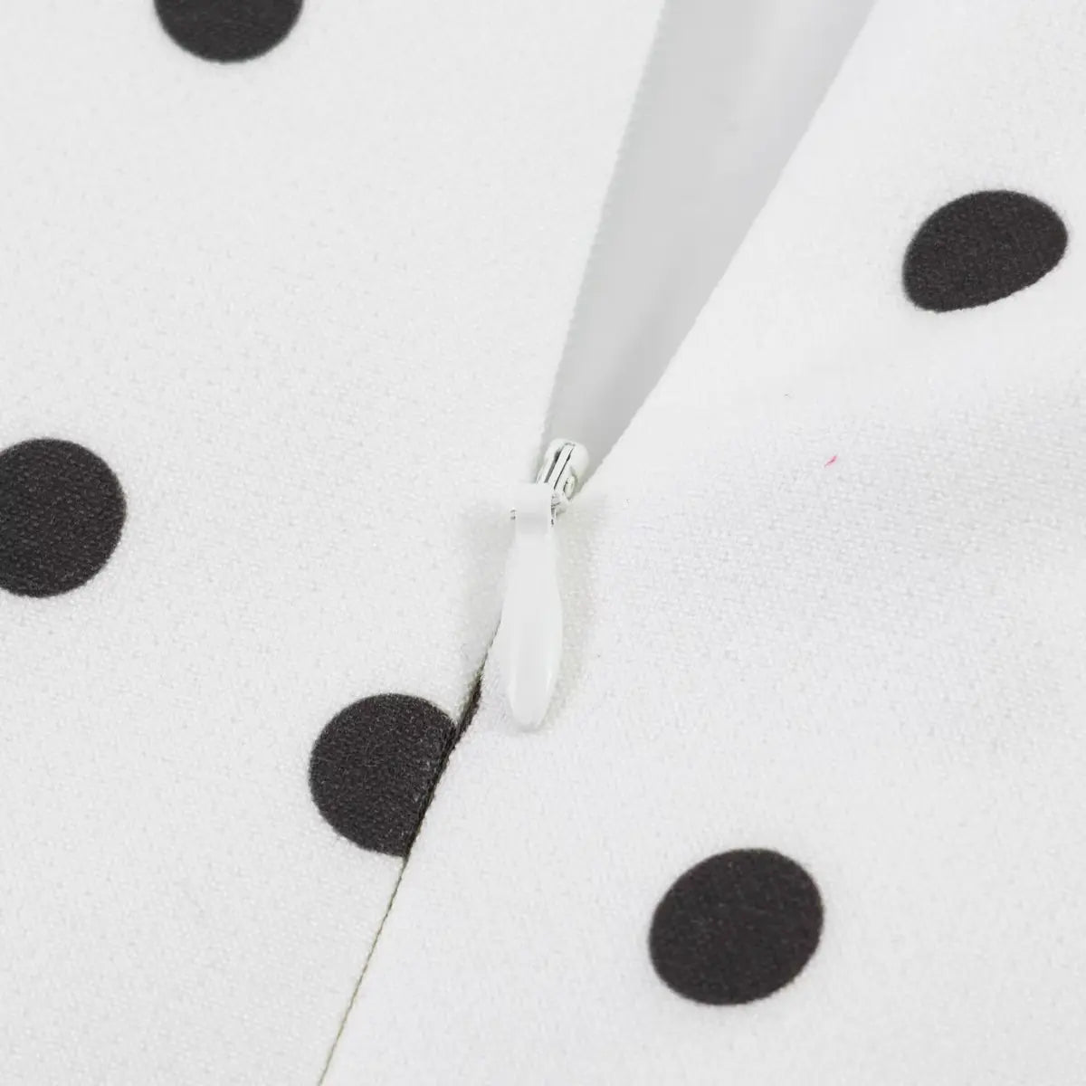 Close-up of the invisible back zipper and finished seam on the polka dot dress.