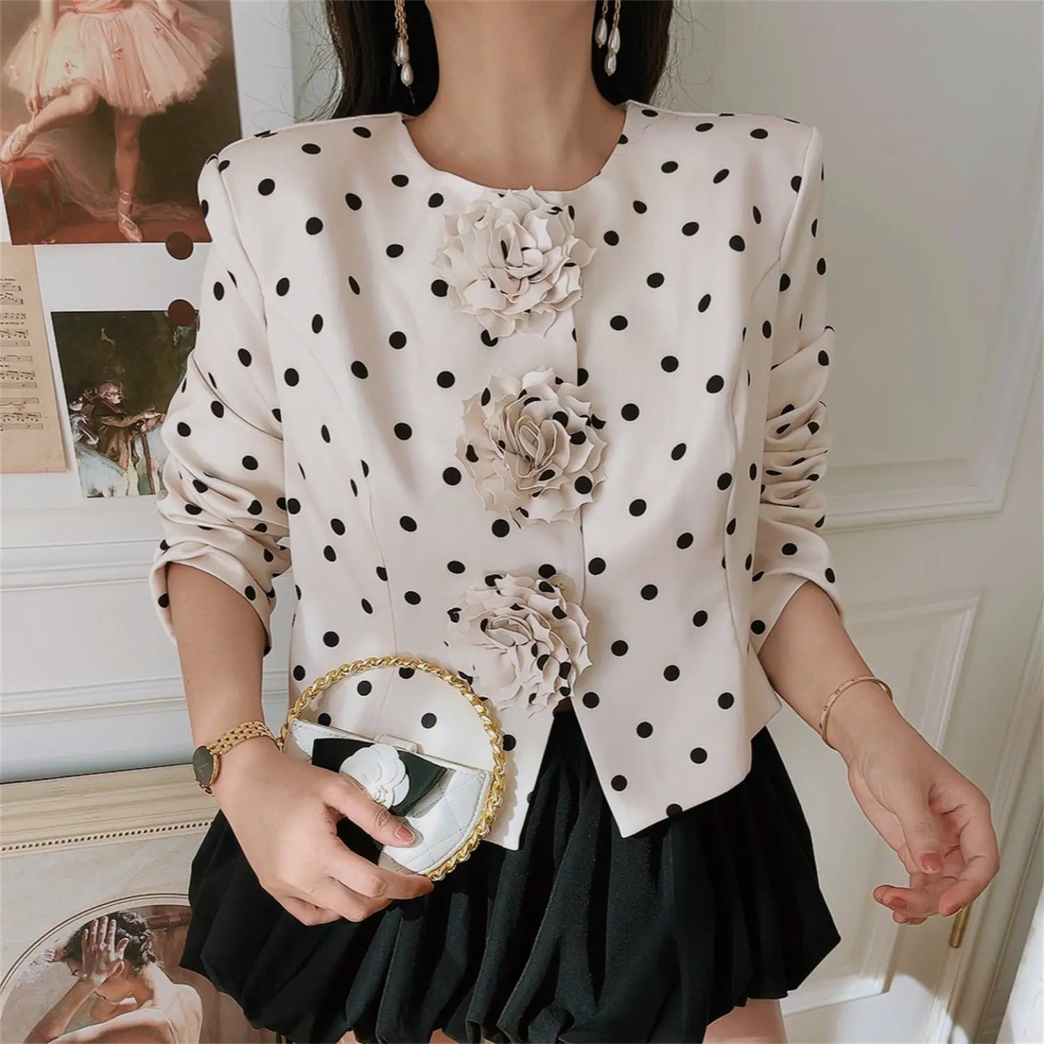 Model front wearing white polka dot cropped jacket with 3D rose flowers, matching black skirt fashion outfit