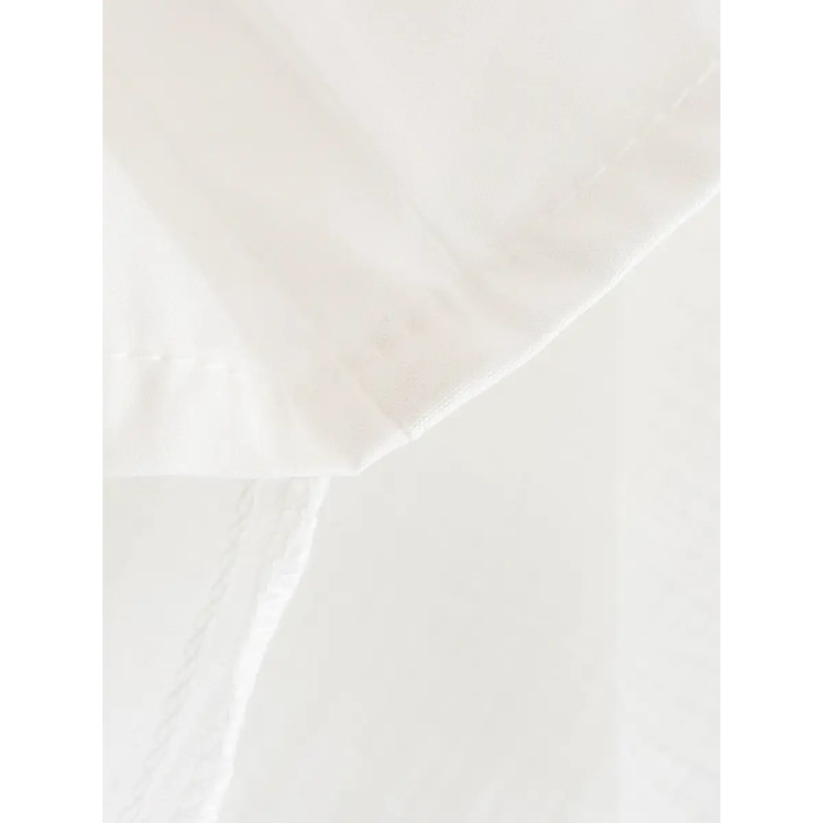 Close-up of the dress's hem, showing the finished seam and lining.