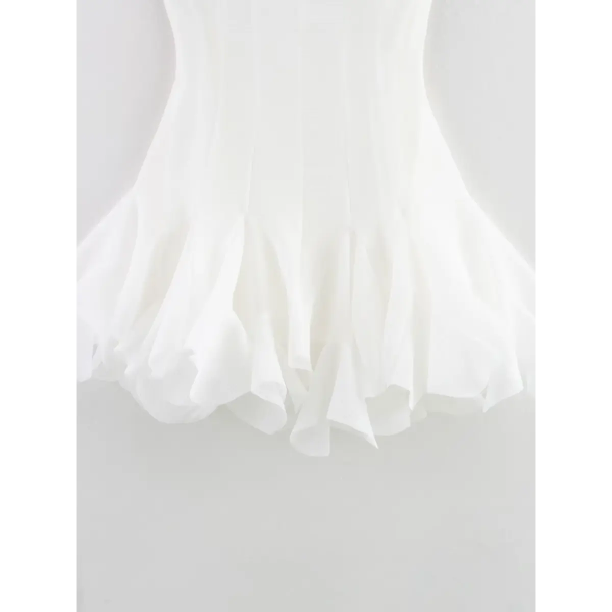 Close-up of the dress's flared, ruffled skirt hem.