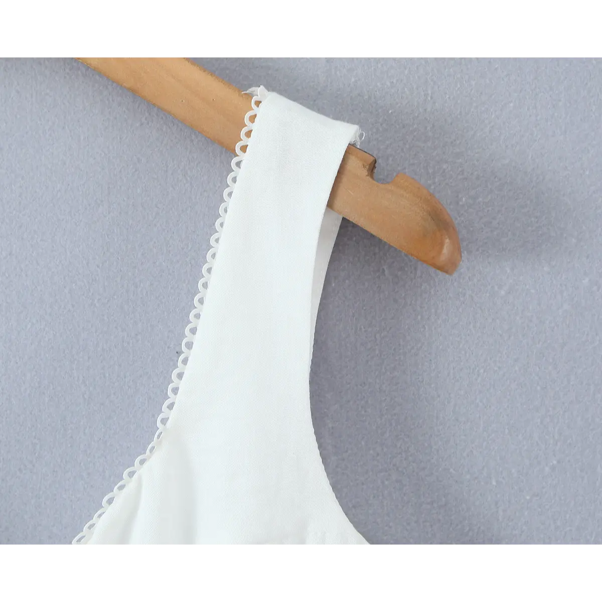 Close-up of the wide strap and delicate scalloped lace trim on the camisole.