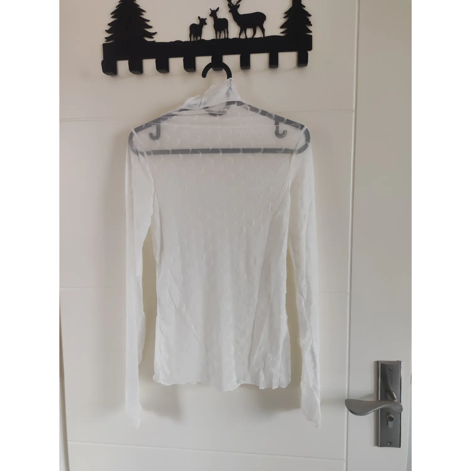 Back view white mesh crescent moon print turtleneck hanging on hanger
