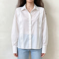 Model wearing white shoulder strap button front shirt with jeans, front view