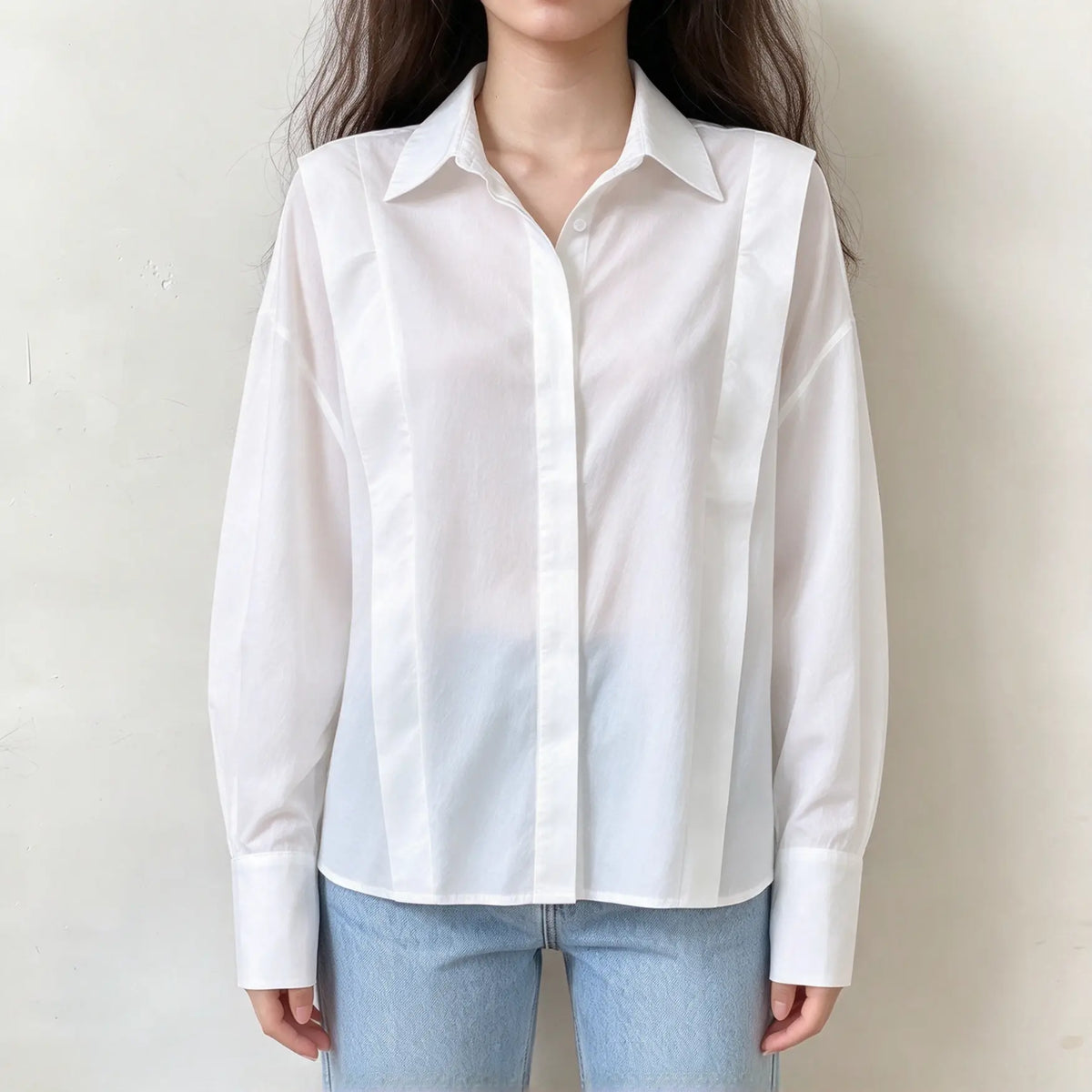 Model wearing white shoulder strap button front shirt with jeans, front view