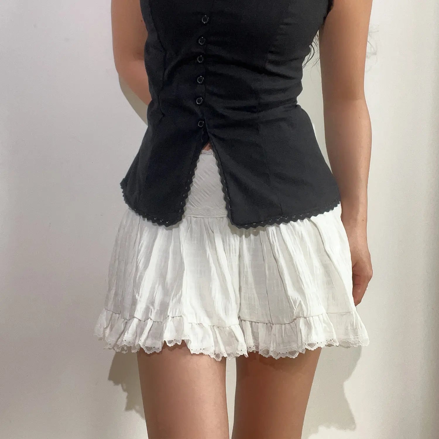 White cake mini skirt match black lace trim cardigan front shot, high waist lace waistband fluffy A-line hem soft layering commuter outfit display