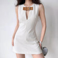 Model front view of white sleeveless mini dress with brown leather buckle accent and front keyhole cutout