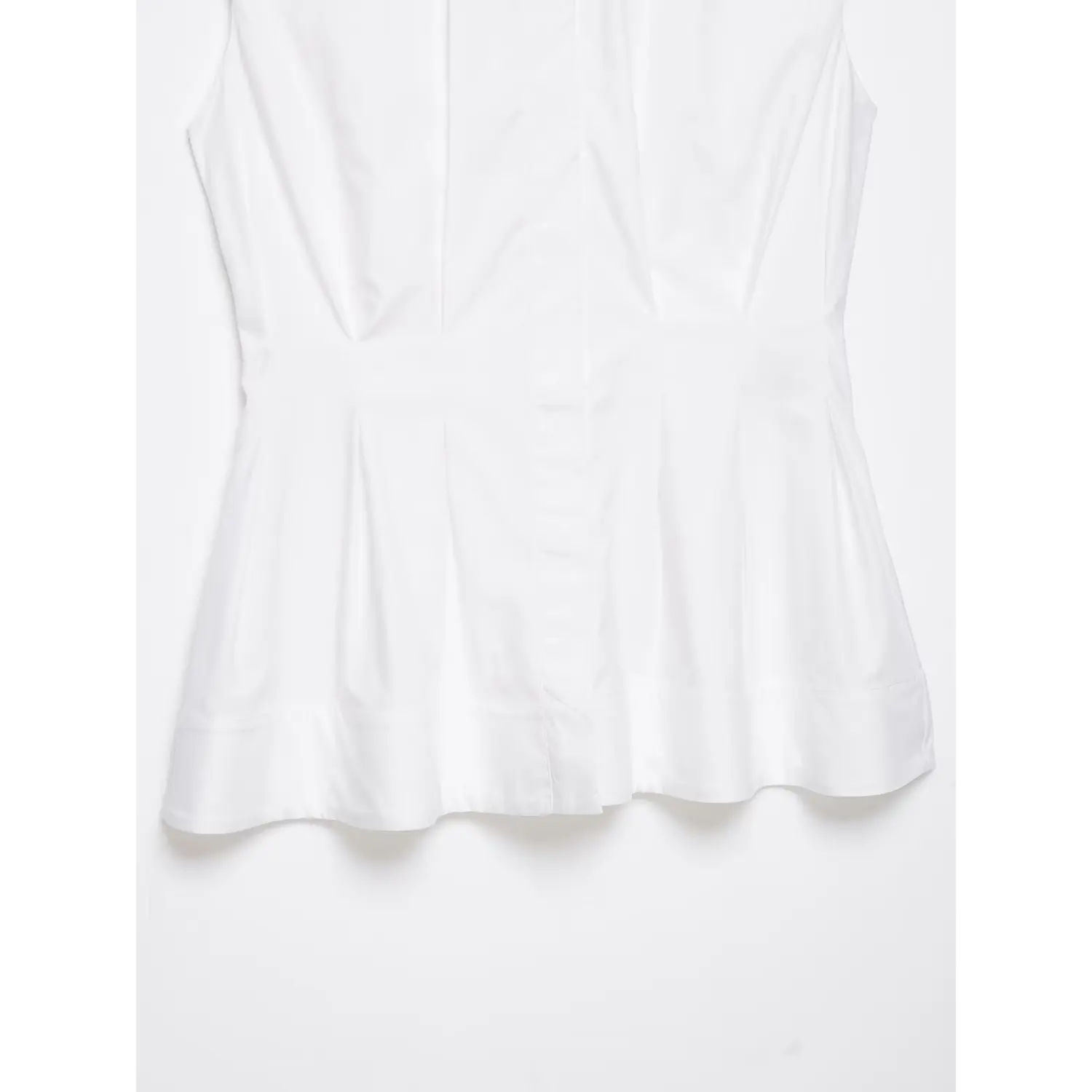 Hem stitching and peplum edge detail of white sleeveless shirt