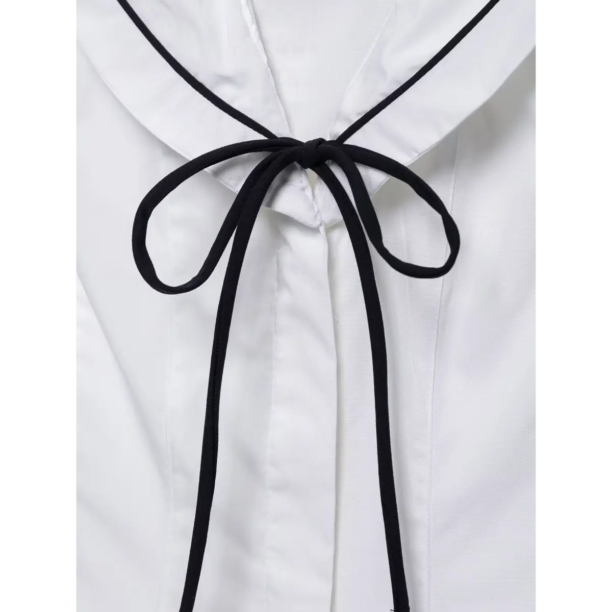 Close-up of the sailor-style collar with black contrast piping.