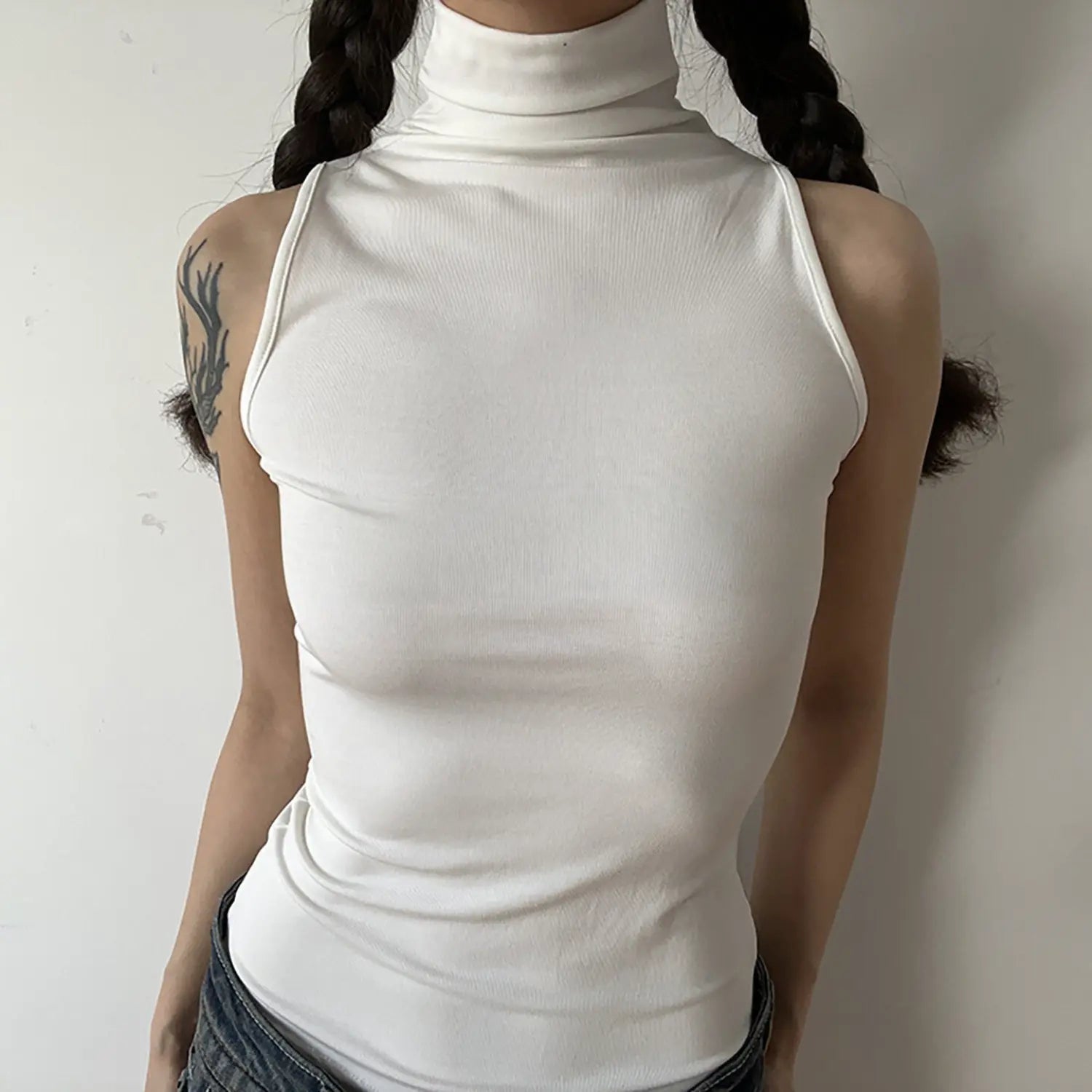 Front torso shot, white sleeveless turtleneck tank top, minimalist fitted design