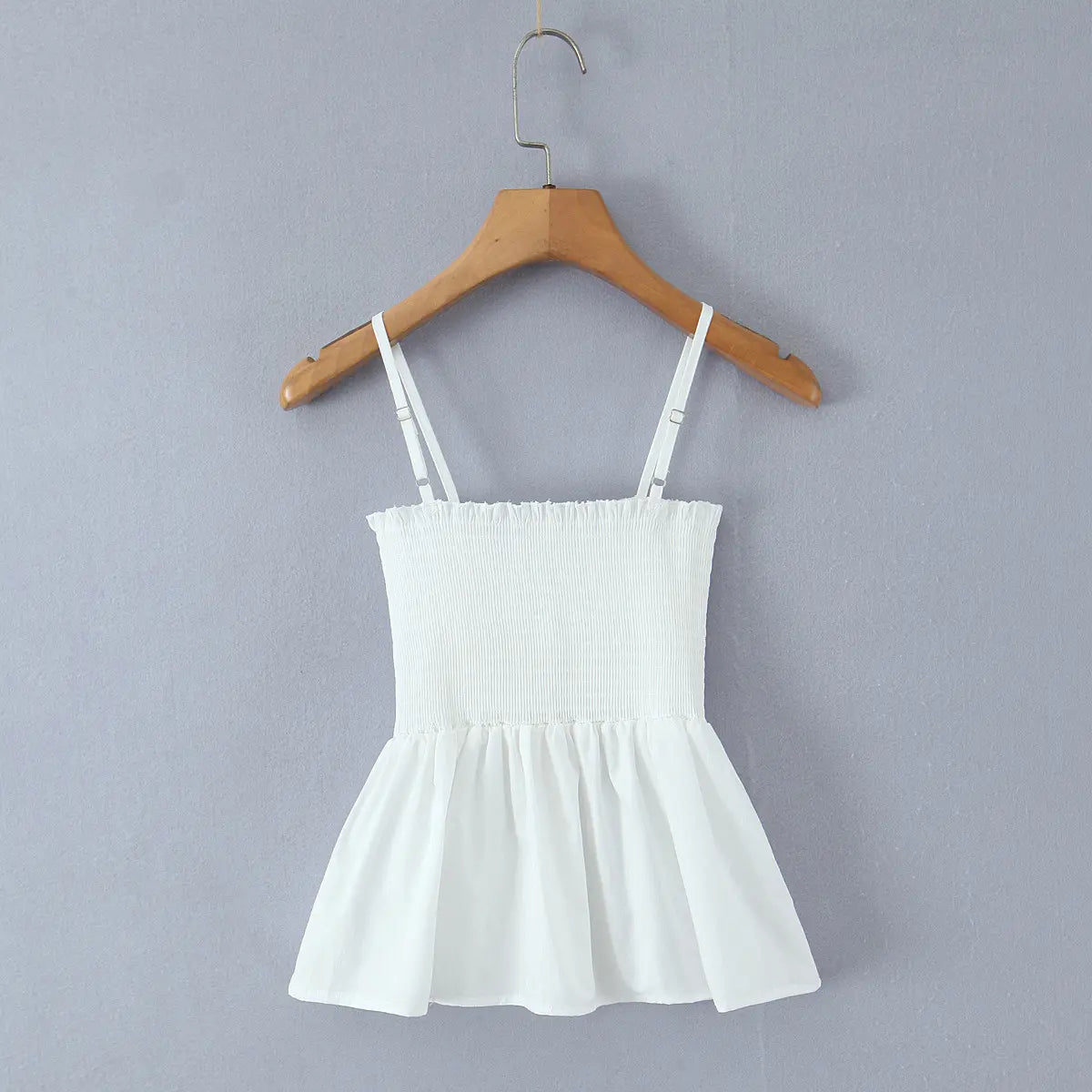 Full back view of white cami top with elastic smocked back panel and fitted silhouette.