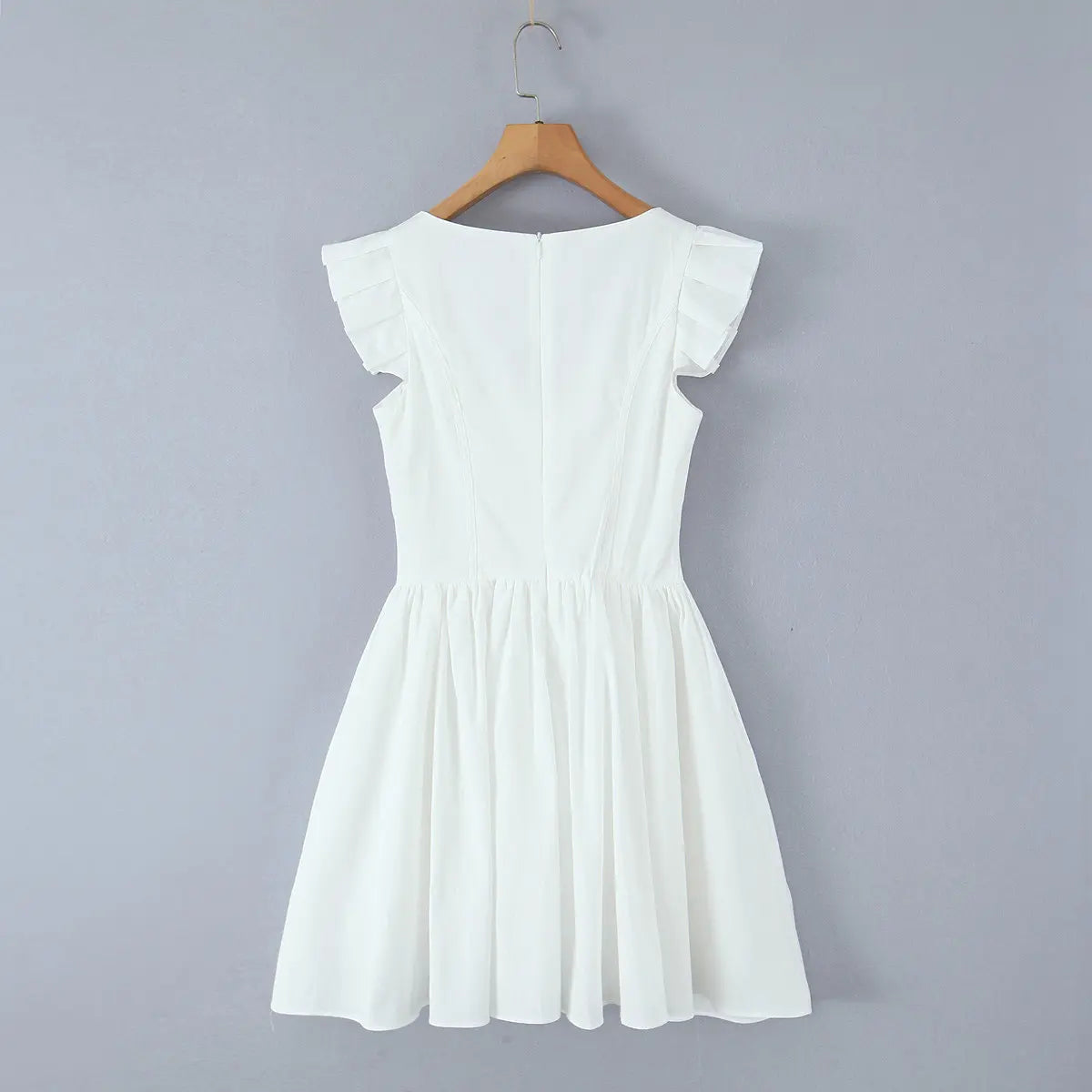  Full back view of the white dress, highlighting the fitted silhouette and flared skirt.