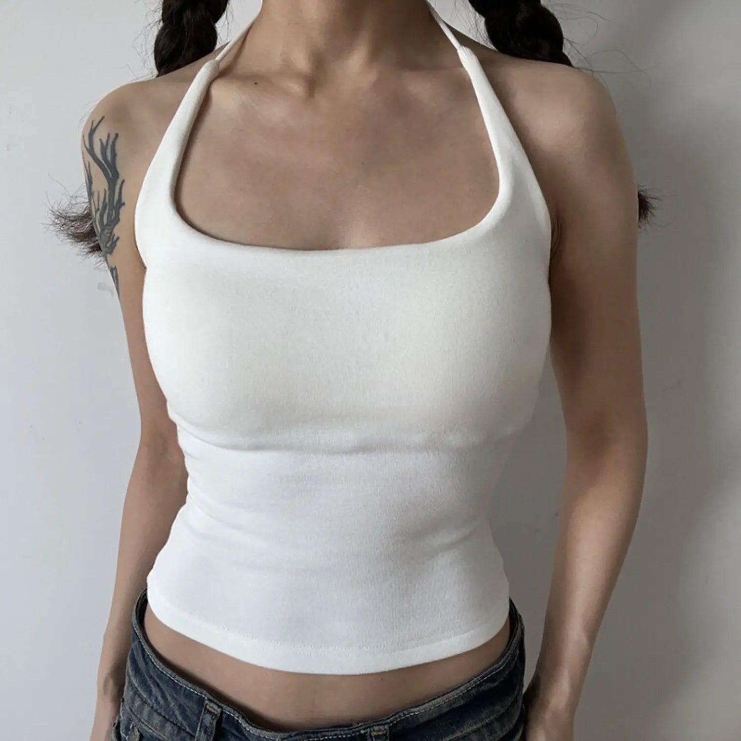 white square neck halter knit cami half body indoor model shot, U wide square neck thin halter tie waist cinched cropped fit matched with denim daily feminine outfit display