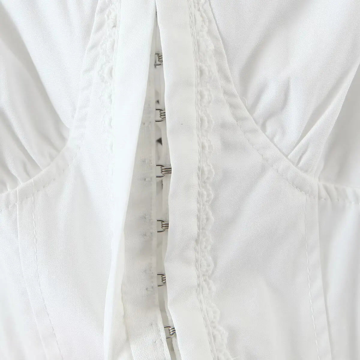 Close-up of the front corset-style lace-up detail with metal eyelets and ribbon.