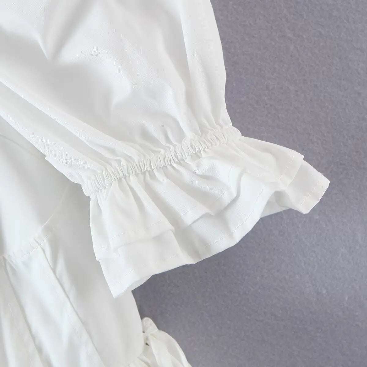 Close-up of the puffed sleeve cuff, featuring the elasticated ruffled edge.