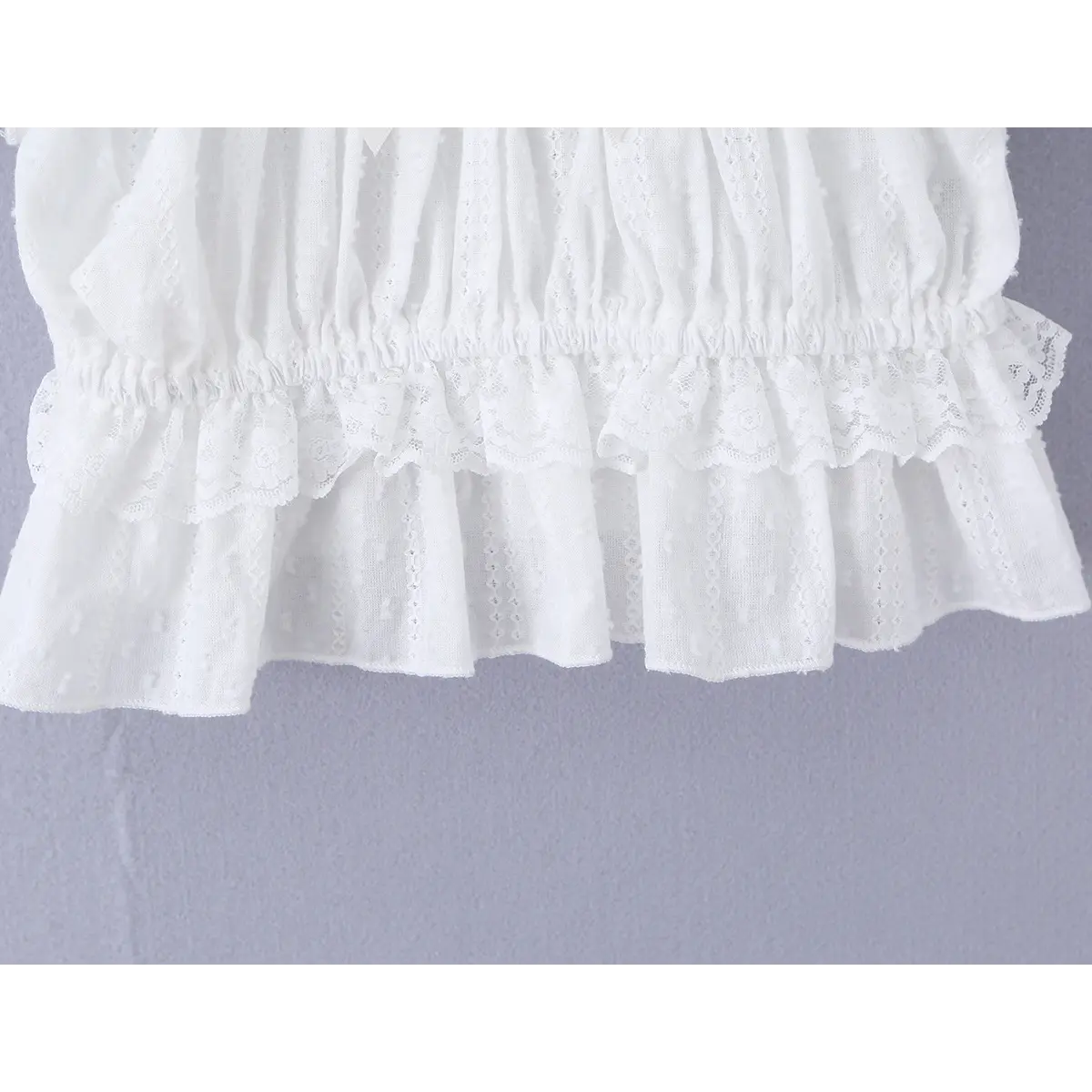 Close-up of the elasticated waistband and layered lace peplum hem.