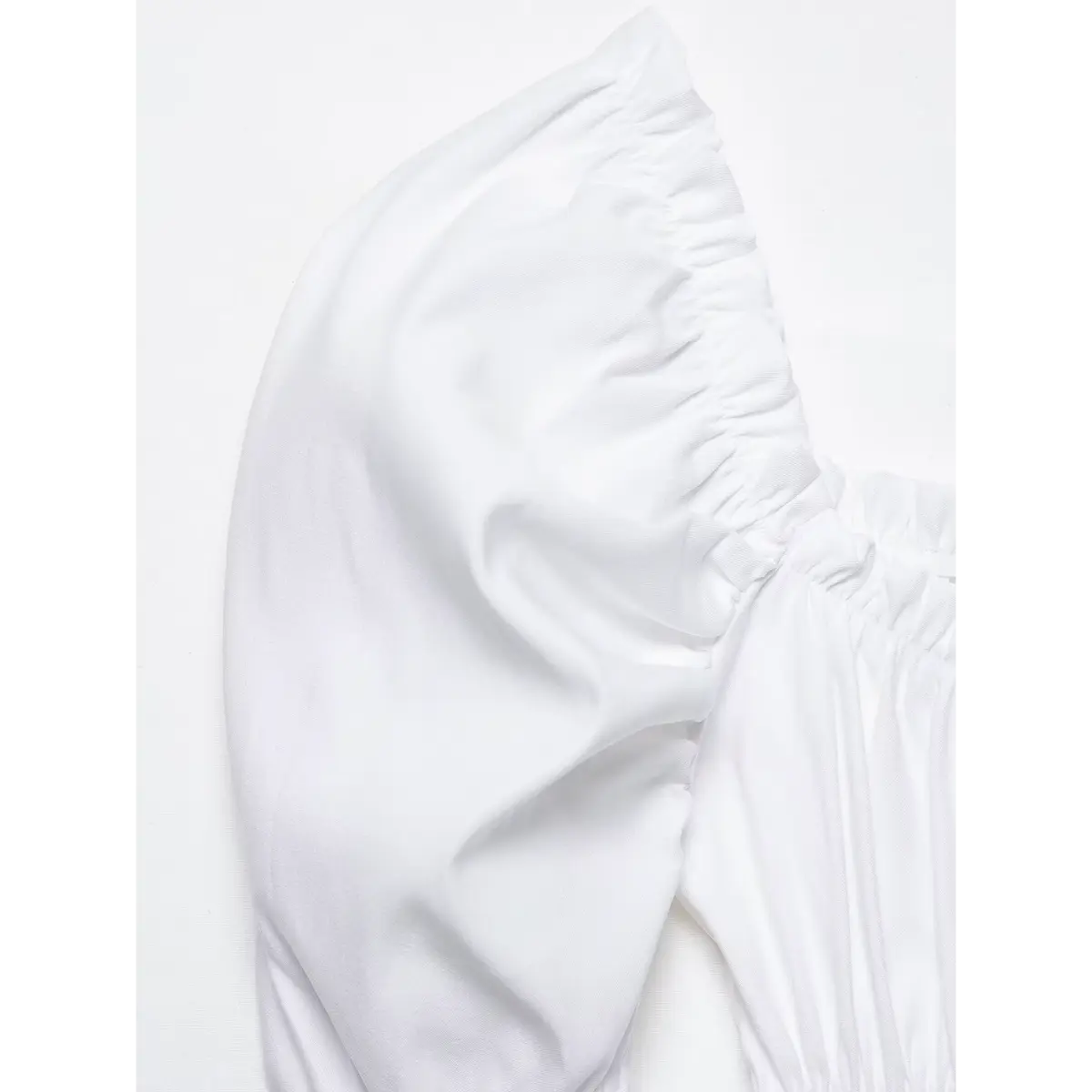 Close-up of the puff shoulder, showing the gathered fabric and structured balloon sleeve.
