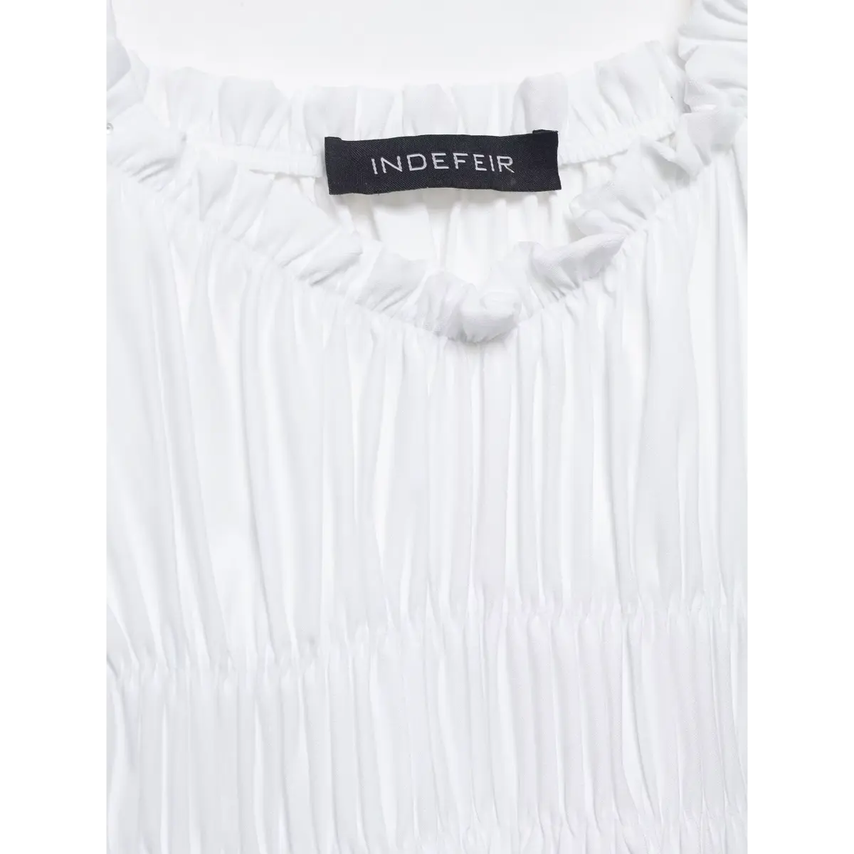 Close-up of the ruffled square neckline, featuring the "INDEFEIR" label and gathered construction.