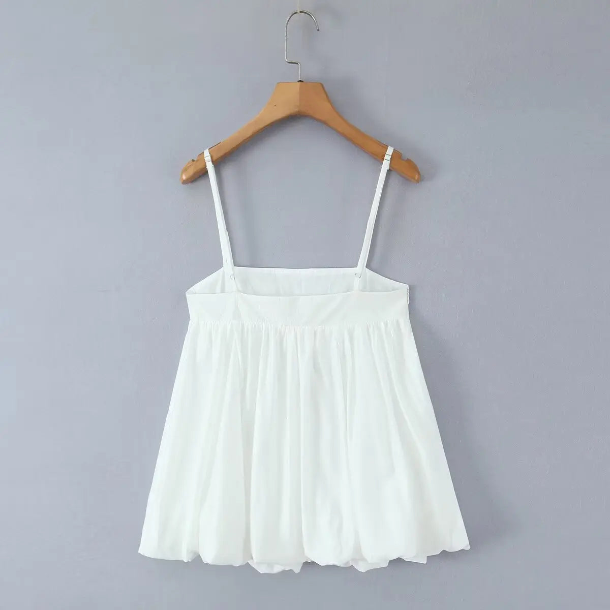 Hanging back view of the dress, showing the adjustable straps and invisible side zipper.