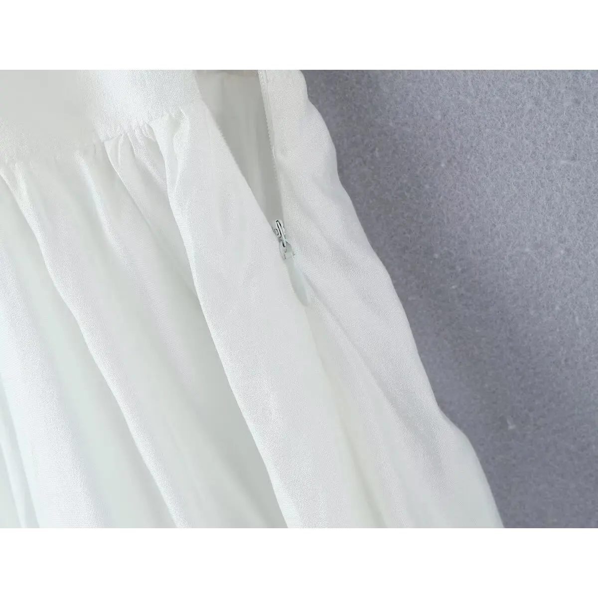 Close-up of the invisible side zipper, seamlessly integrated into the dress.