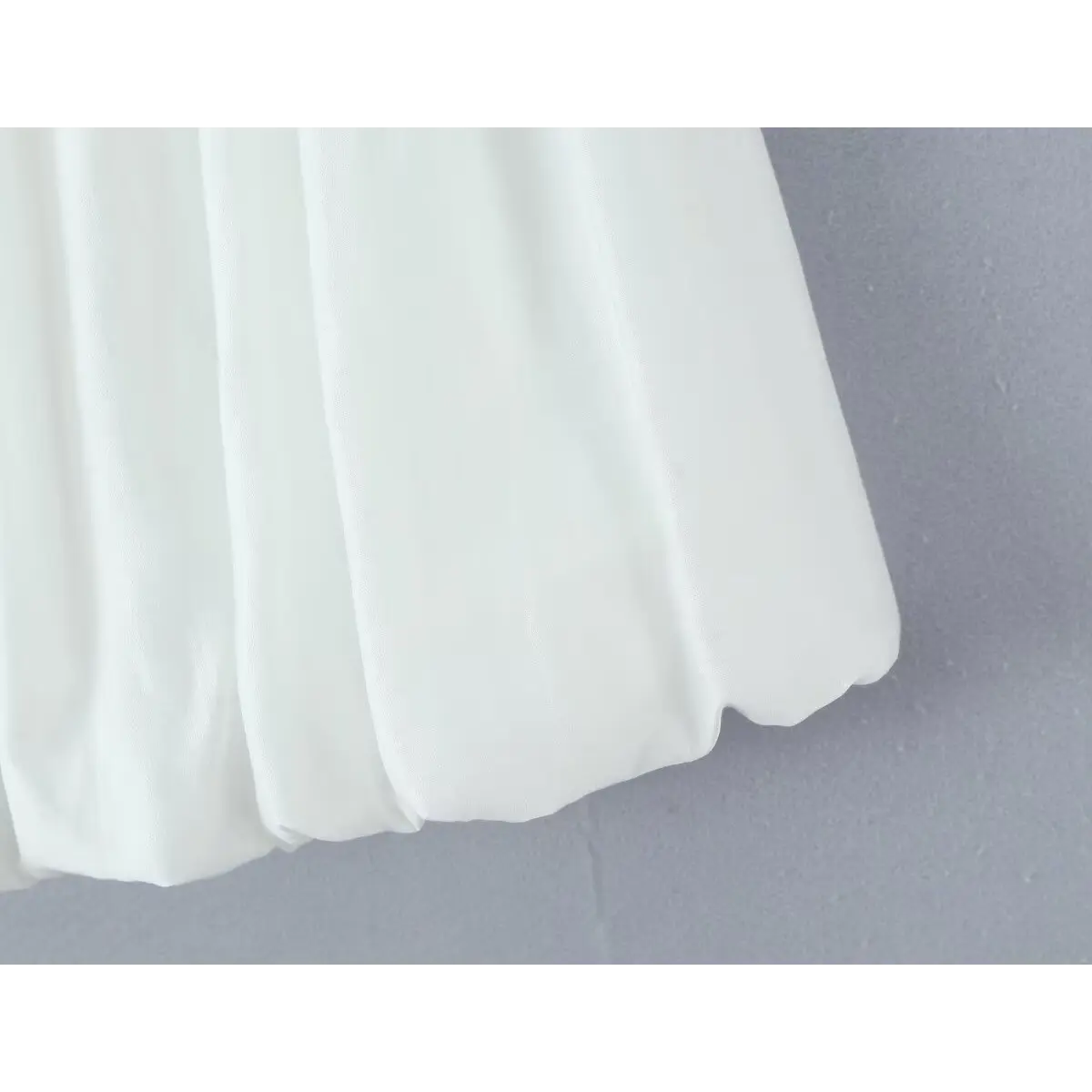 Close-up of the finished bubble hem edge, showing the clean stitching that creates the structured shape.