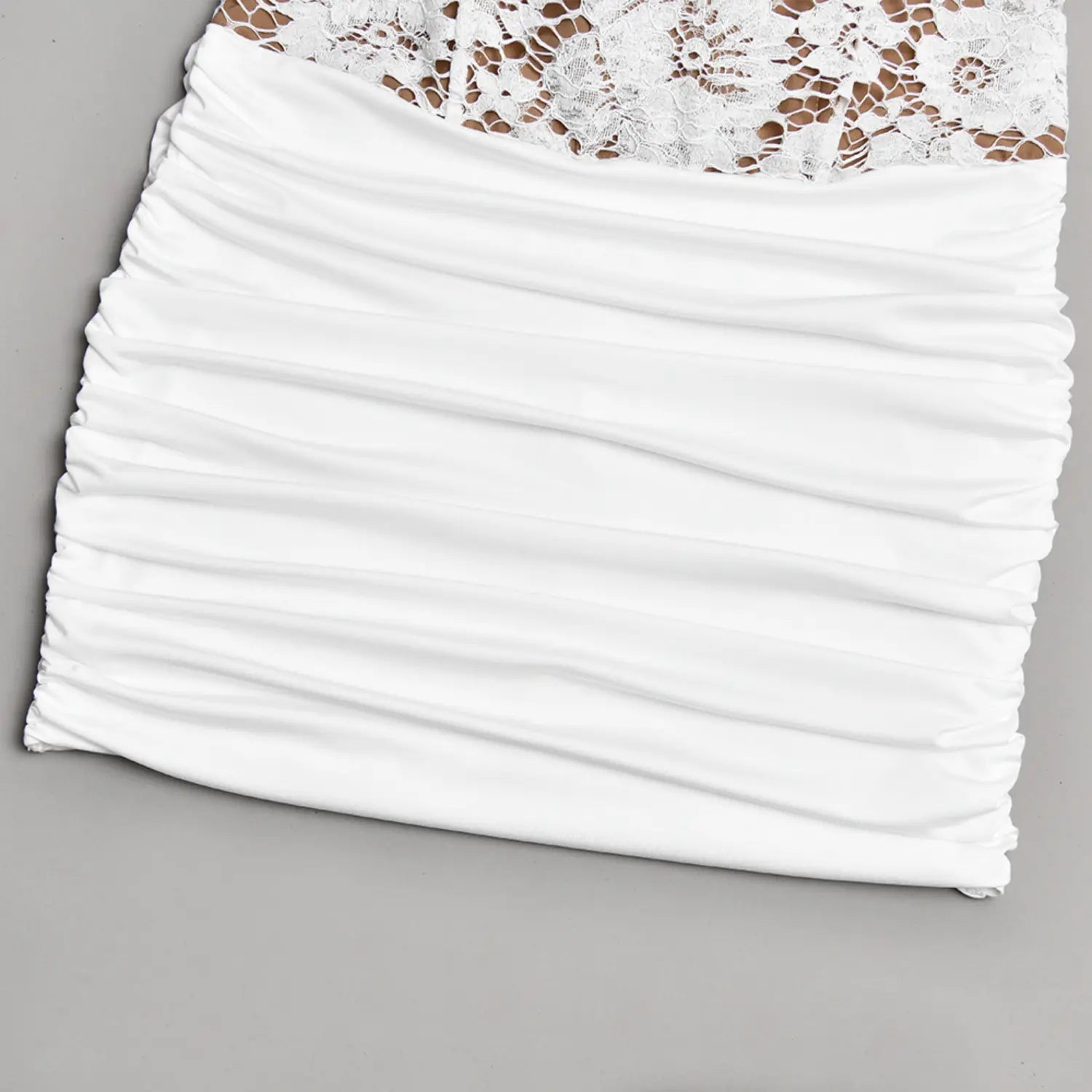 Flat lay close‑up of horizontal ruched stretch fabric for white mini dress skirt