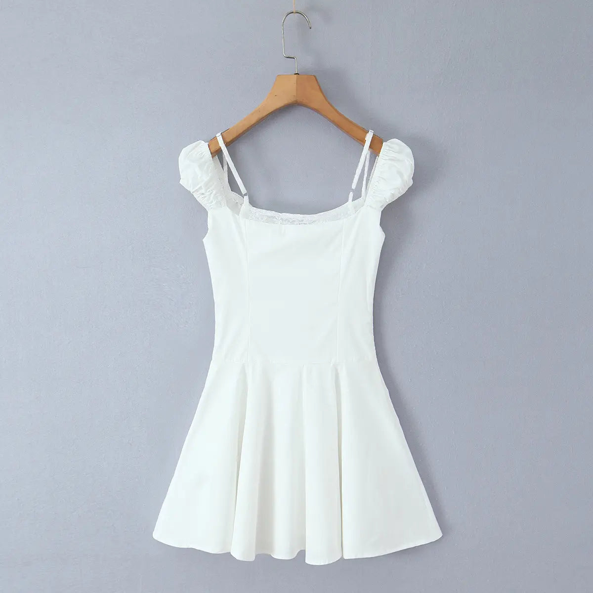  Full back view of the white puff-sleeve mini dress on a wooden hanger, showing square back neckline