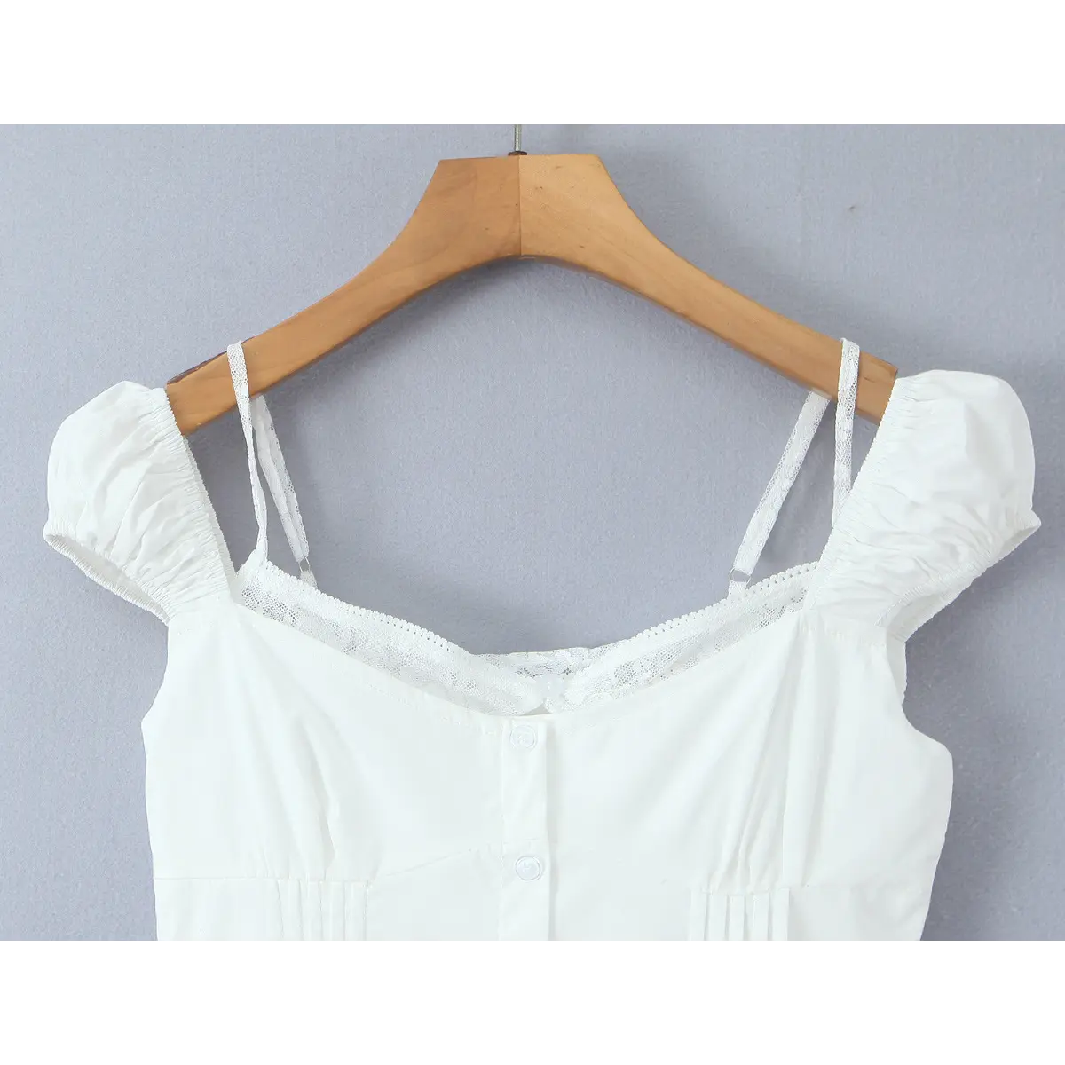 Close-up of the sweetheart neckline with lace trim and gathered puff sleeves
