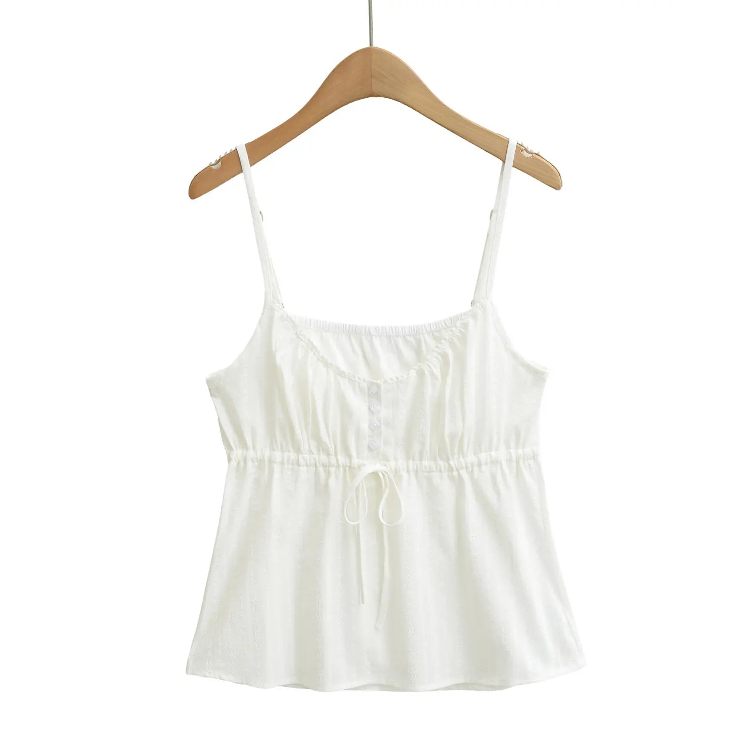 Front view of a white textured camisole top on a wooden hanger, showing the button placket and drawstring