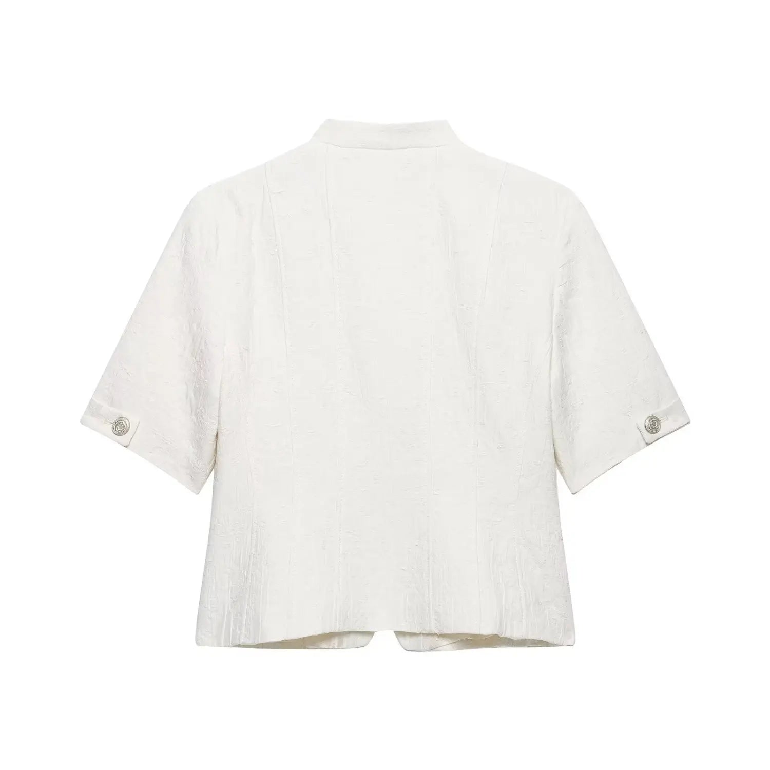 Flat‑lay back view of white textured cropped short sleeve jacket, stand collar, sleeve cuff silver buttons, structured seam details, white background