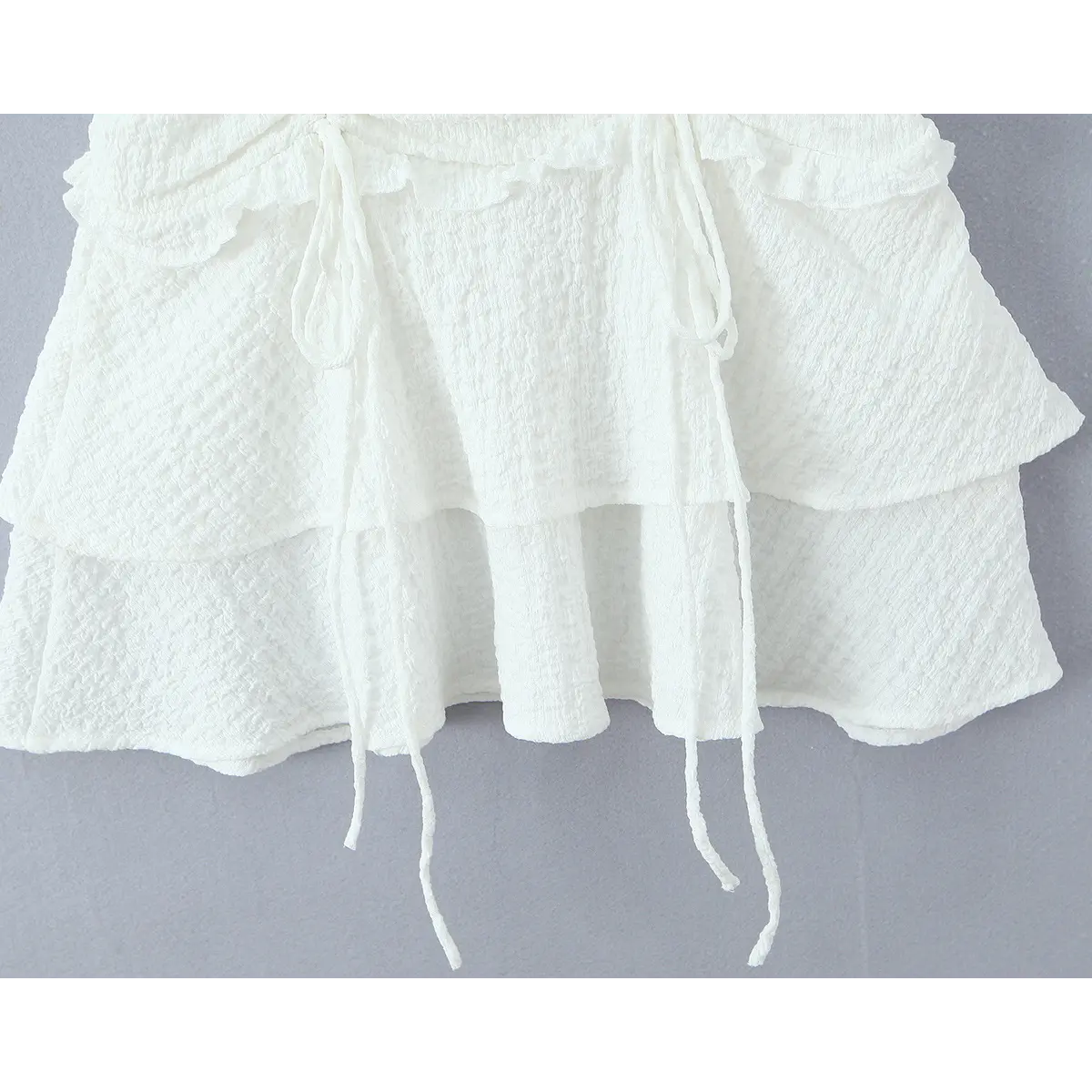 Full view of the tiered ruffle skirt hem with the drawstring ties.