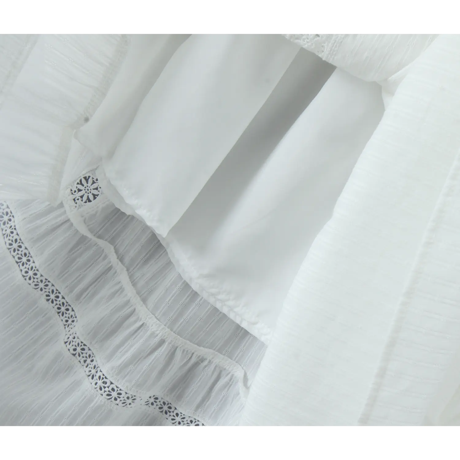 Close-up of the inner lining and tier construction on a white maxi skirt