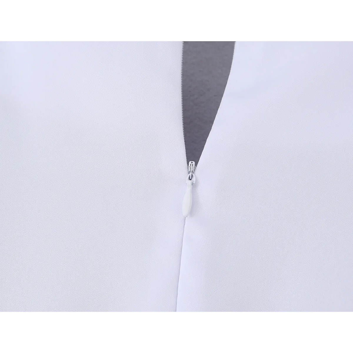 Close‑up of concealed back zipper on white dress
