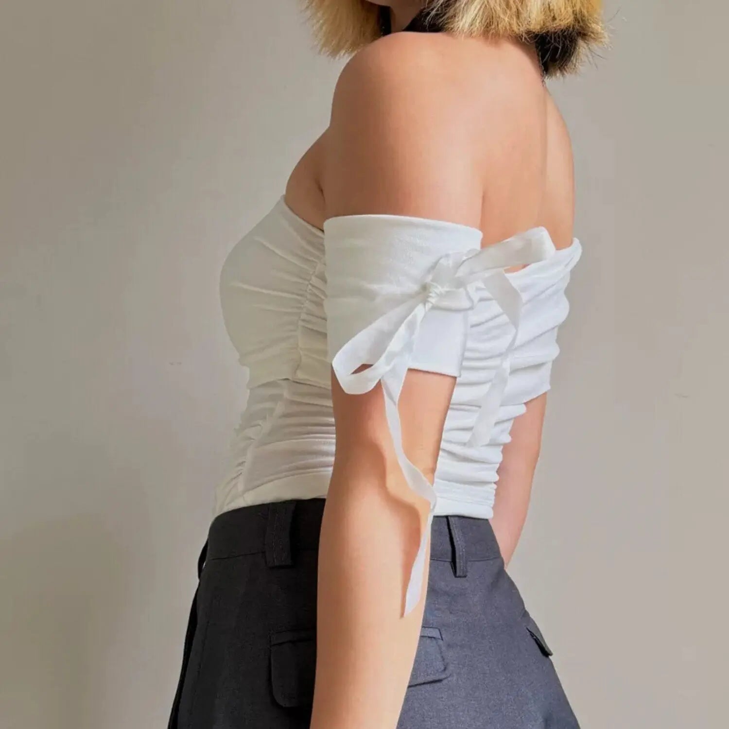 Women white fold over off shoulder ruched crop top with detachable ribbon bow short sleeve, back side model shot