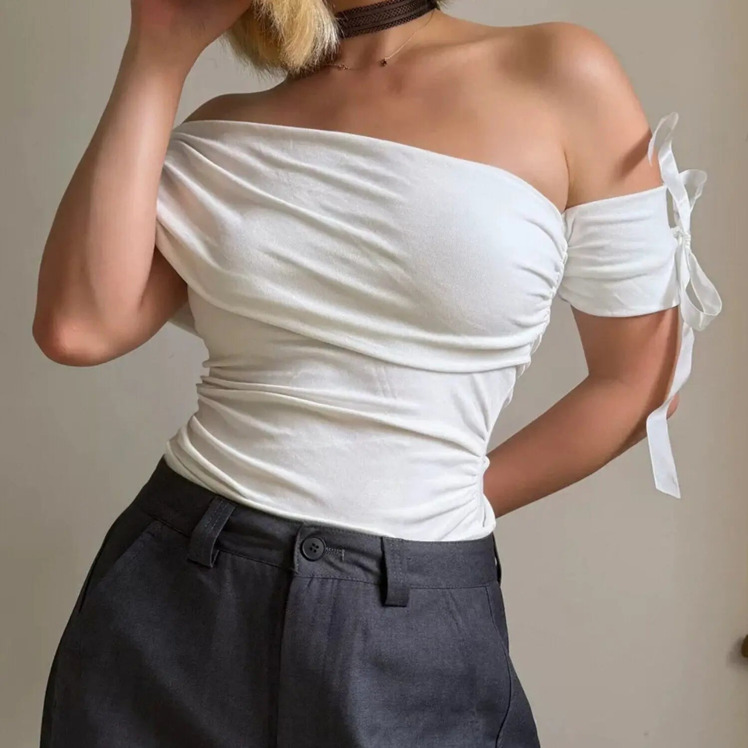 White fold over off shoulder stretch top with detachable ribbon bow sleeve, waist ruched slim fit side pose