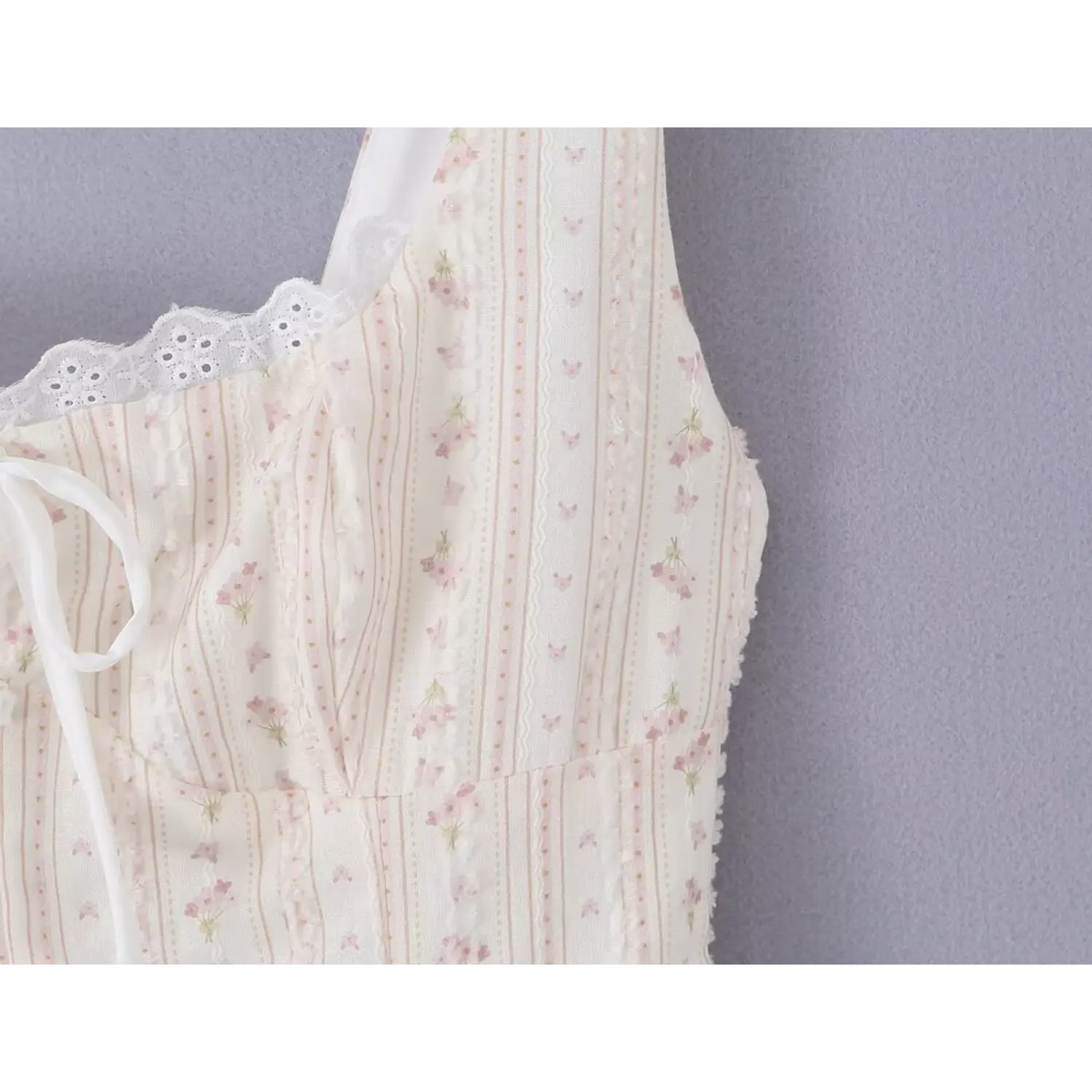 Shoulder neck partial close-up wide solid matching fabric straps, ruffled frill textured floral print, elastic eyelet lace square neckline edge