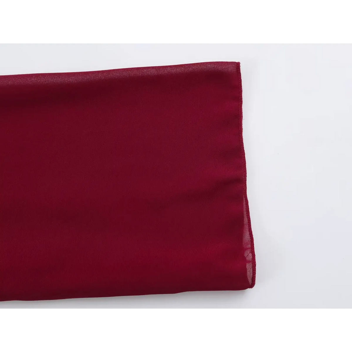 Close-up of lightweight wine red chiffon fabric with natural folds