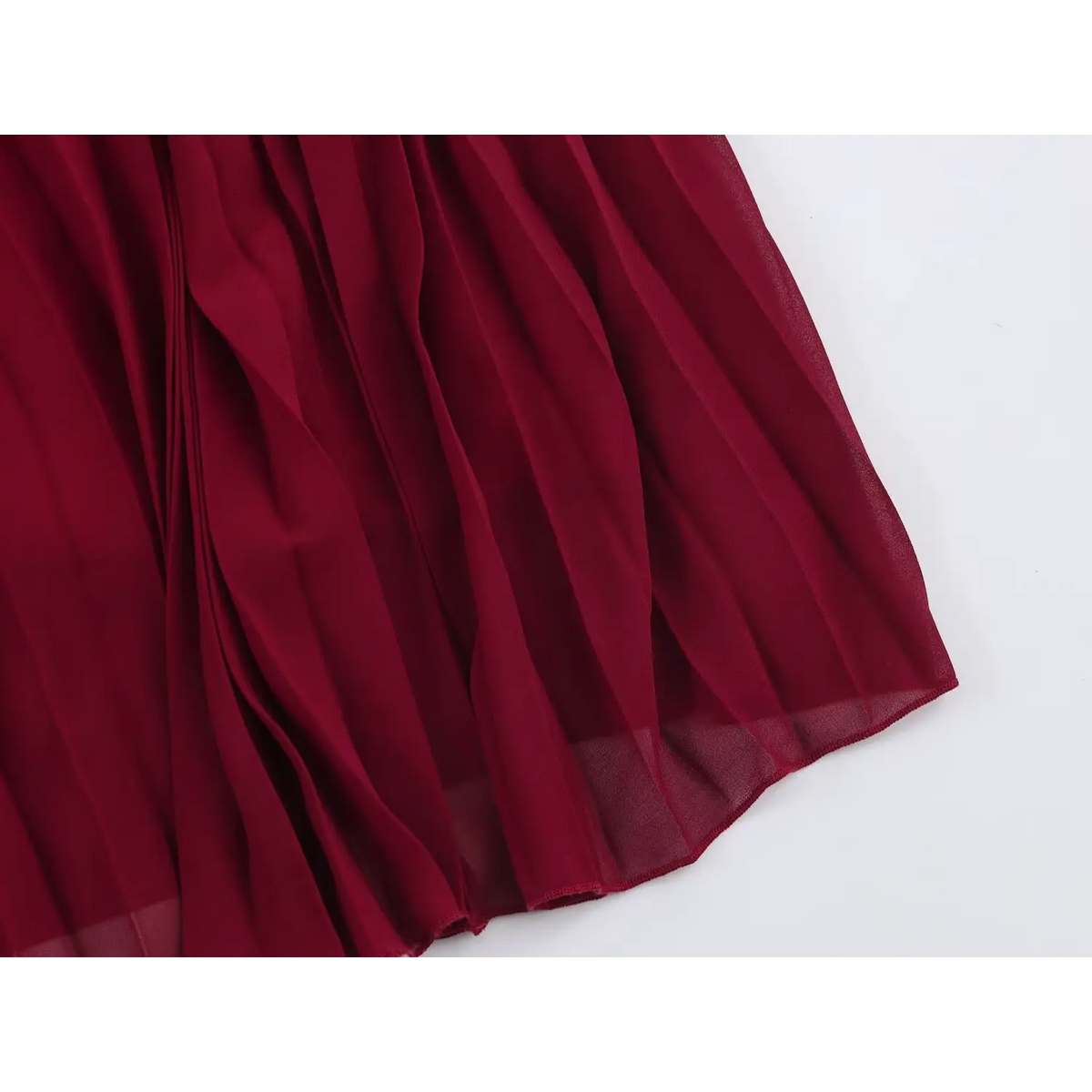 Close-up of pleated wine red chiffon fabric with neat edge stitching