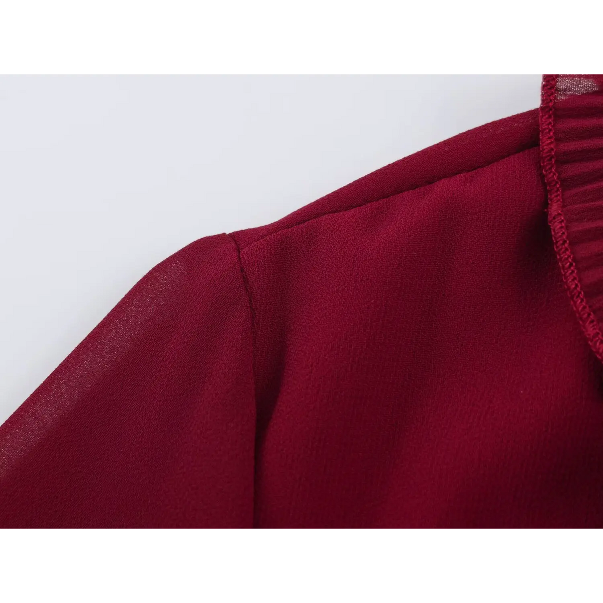 Close-up of shoulder and neckline seam of wine red chiffon maxi dress with fine stitching