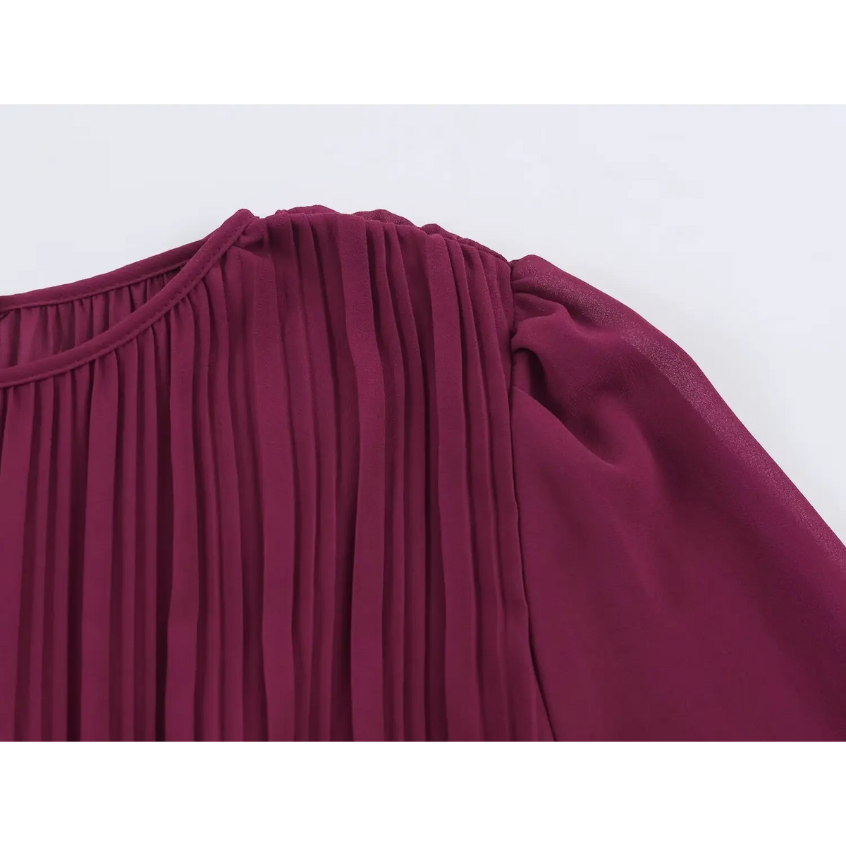 Close-up of neckline, pleated bodice and puff sleeve of wine red chiffon maxi dress