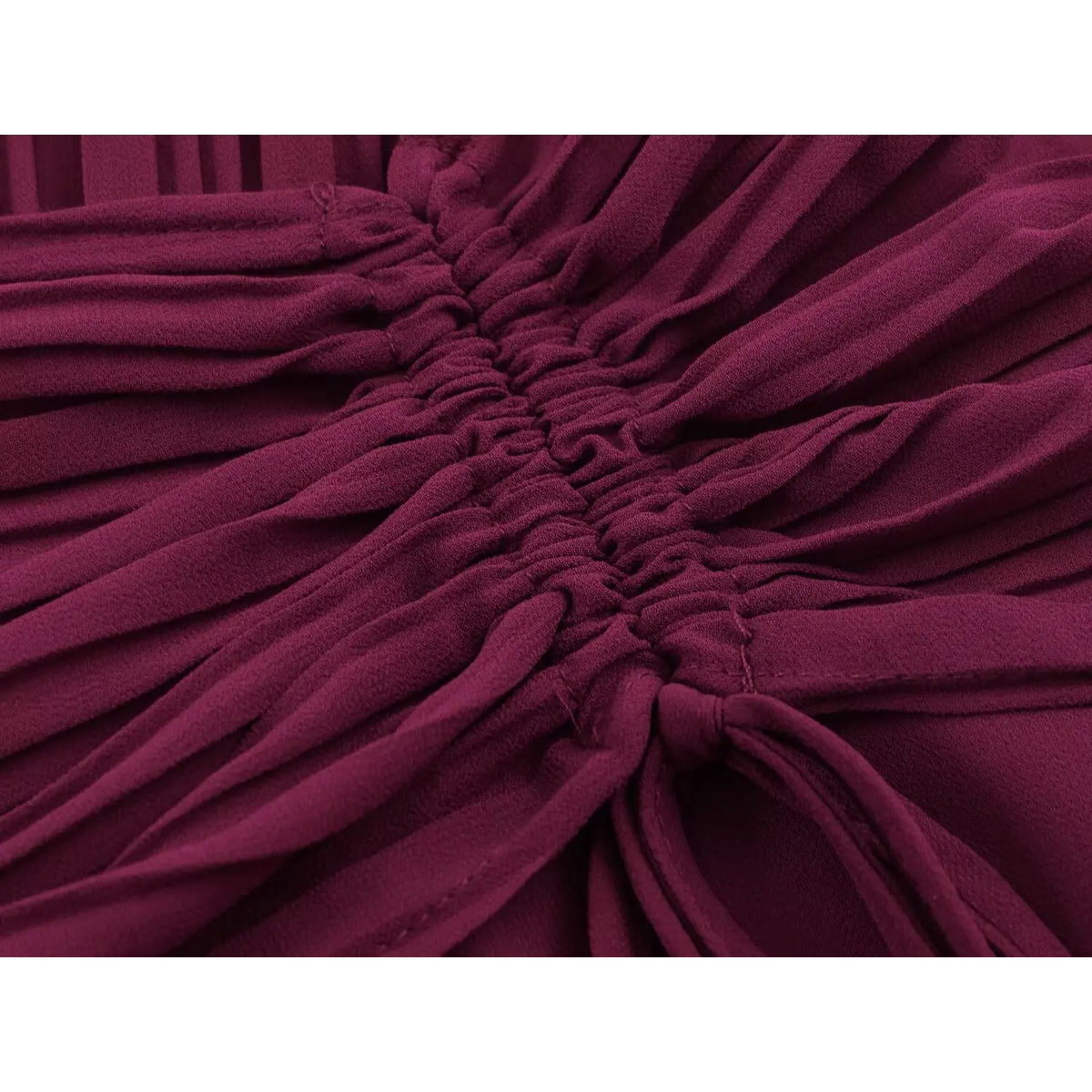 Close-up of drawstring waist with knotted tie on wine red maxi dress