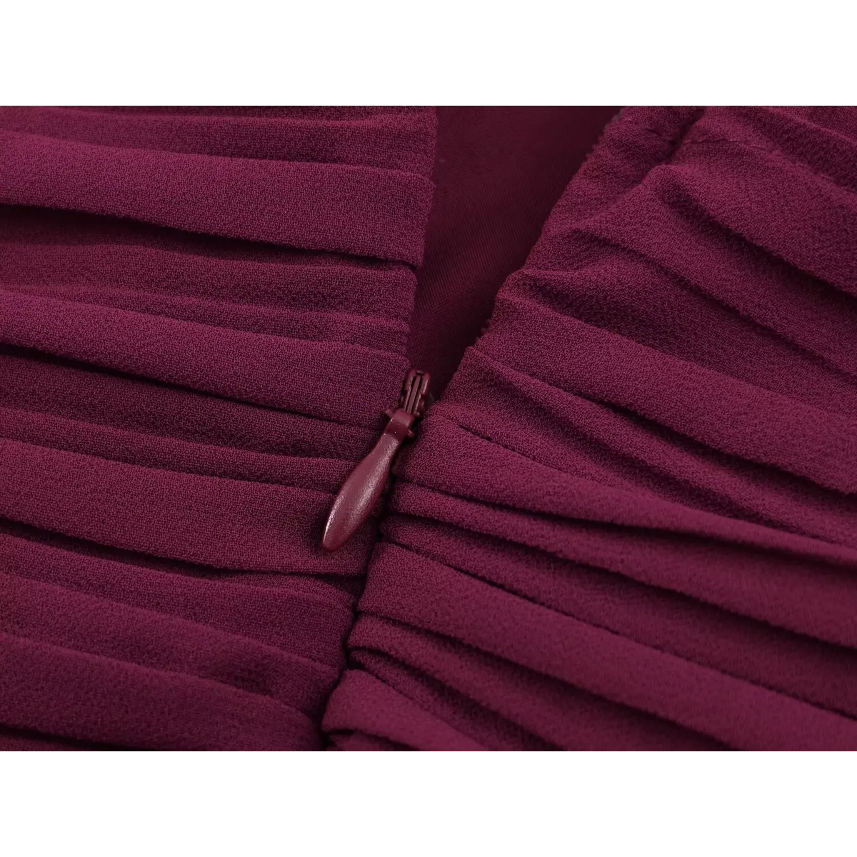 Close-up of matching drop-shaped zipper pull on wine red pleated fabric