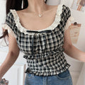 Women black white plaid lace square neck crop top, front tie ruffle hem, indoor half body model photo