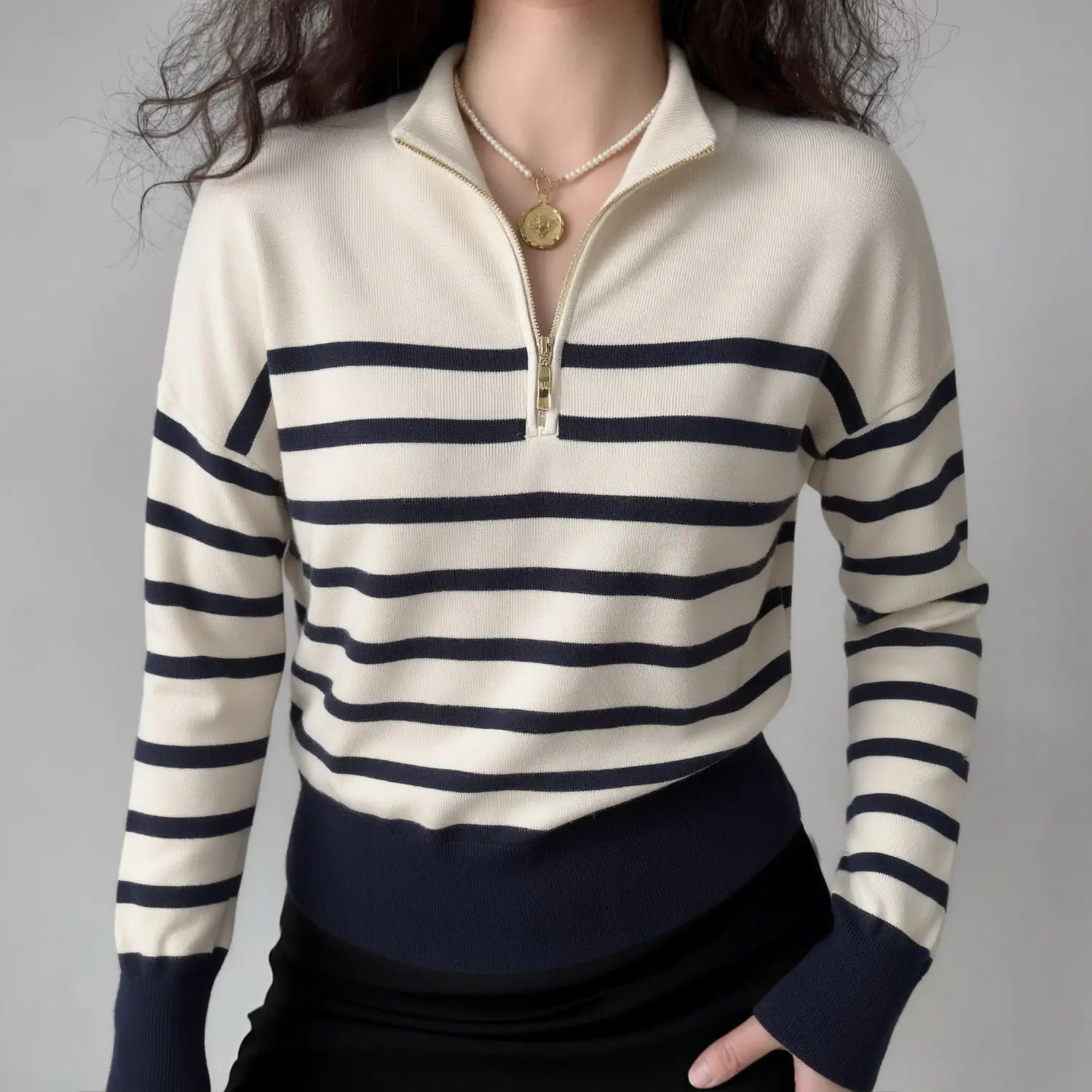 Model wearing cream navy horizontal‑stripe half‑zip mock neck knit sweater, casual fitted look