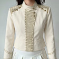Outfit shot women wearing off-white gold braided cropped jacket with white skirt