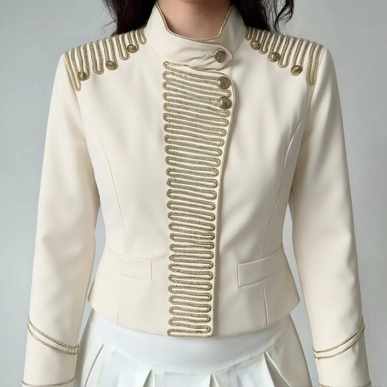 Outfit shot women wearing off-white gold braided cropped jacket with white skirt