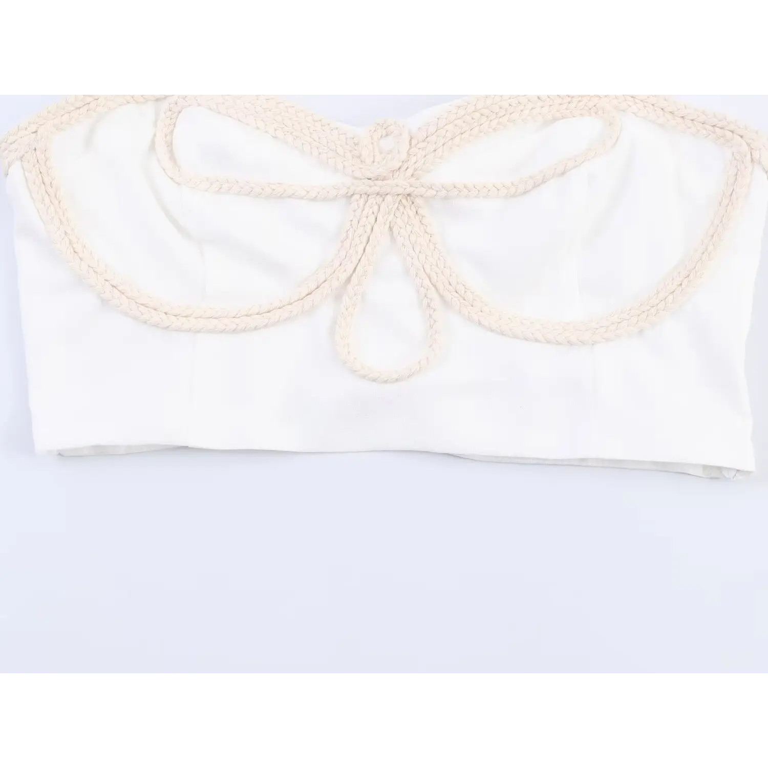 Macro close-up of beige braided rope butterfly front appliqué detail on white crop cami