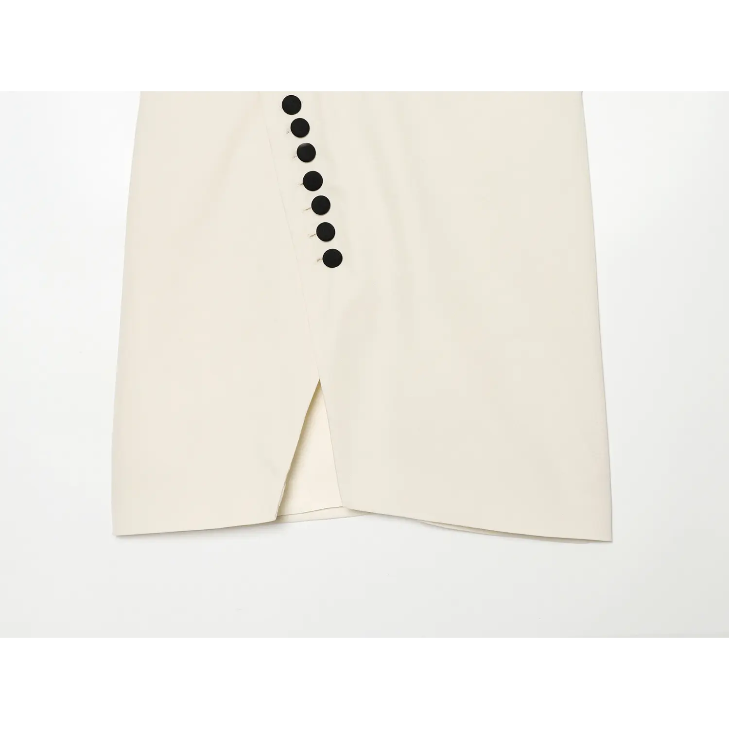 Front wrap split hem detail on cream sleeveless halter top