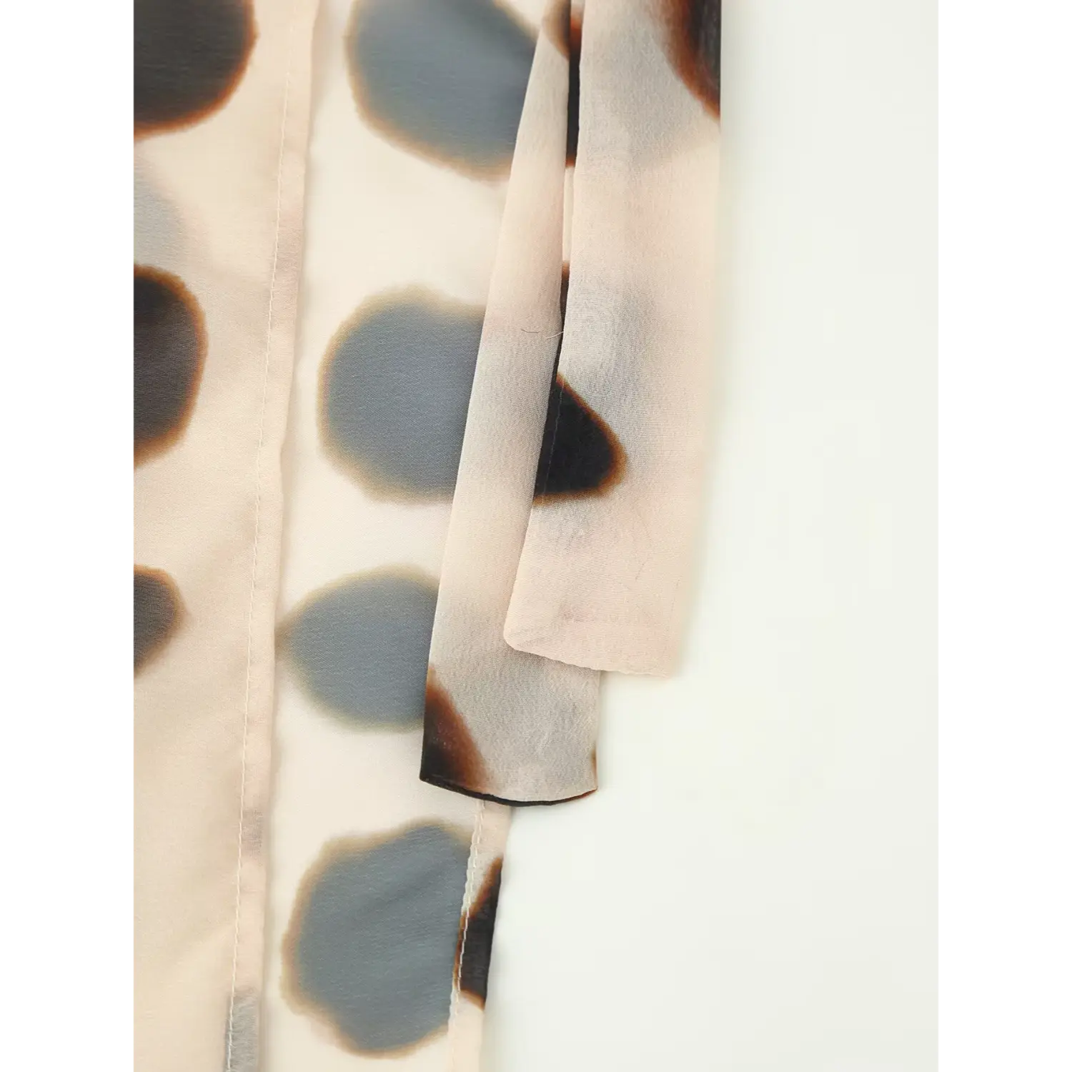 Long matching fabric side tie strap detail of neutral tone watercolor dot wrap chiffon skirt