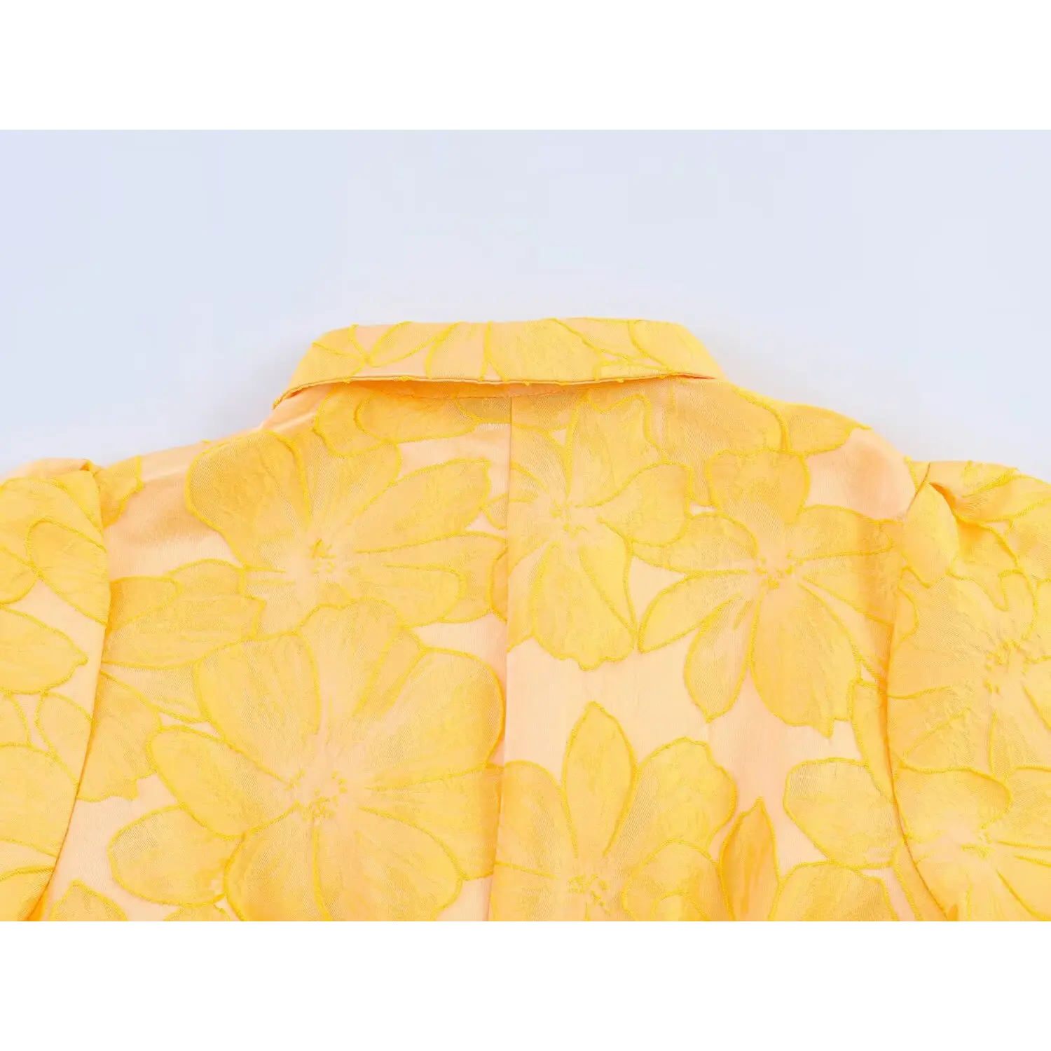 Close-up of stand shirt collar back and embossed floral fabric texture
